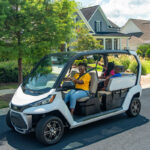 Woman driving CRU in residential neighborhood