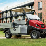 Red Carryall Golf Car Parked in front of Complex